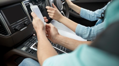 Two people inside of car seeing how to use we buy any car near me service