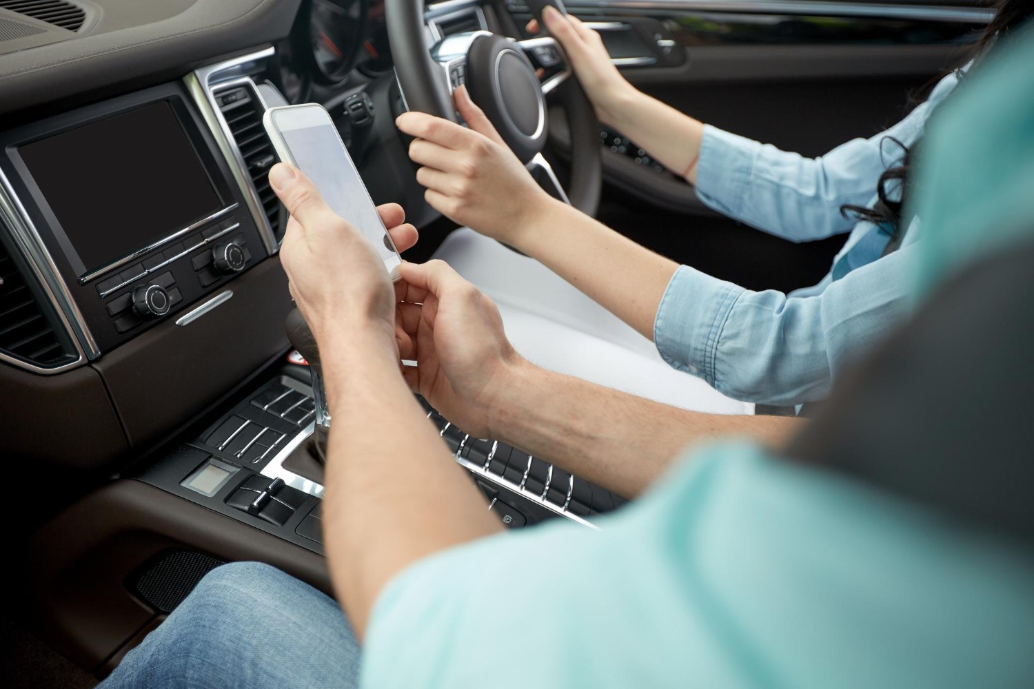 Two people inside of car showing how to sell their car