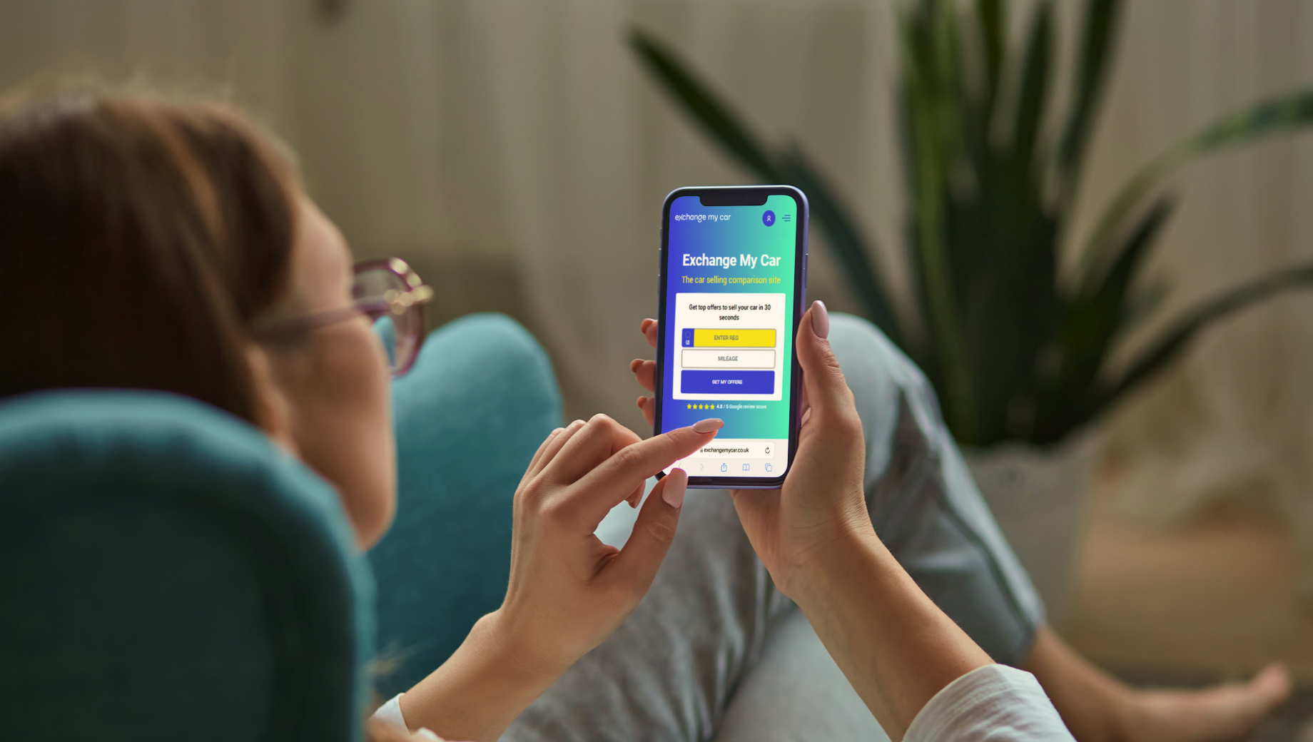 A person sitting in home and getting a free car valuation