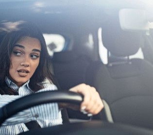 girl test driving a car